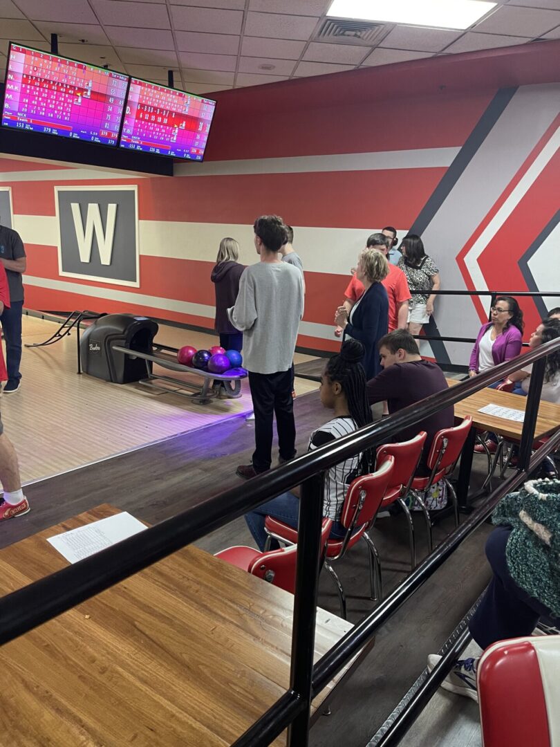 Group of people playing bowling game at a place