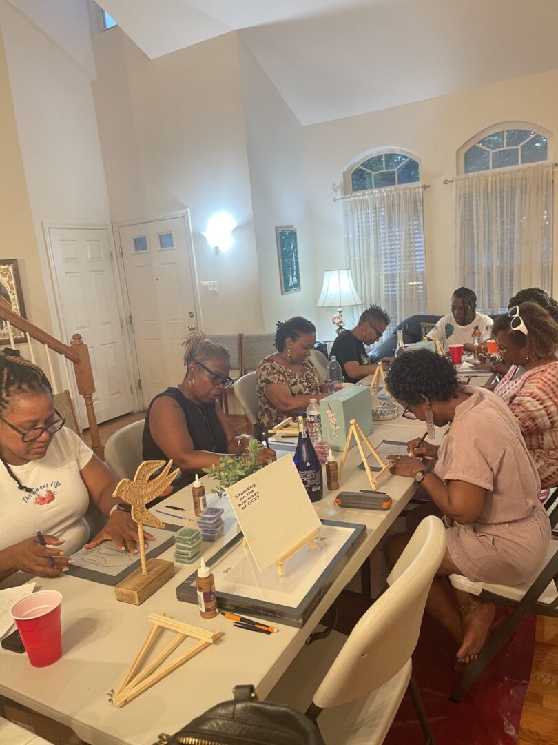 A group of women crafting together at a well-lit table.