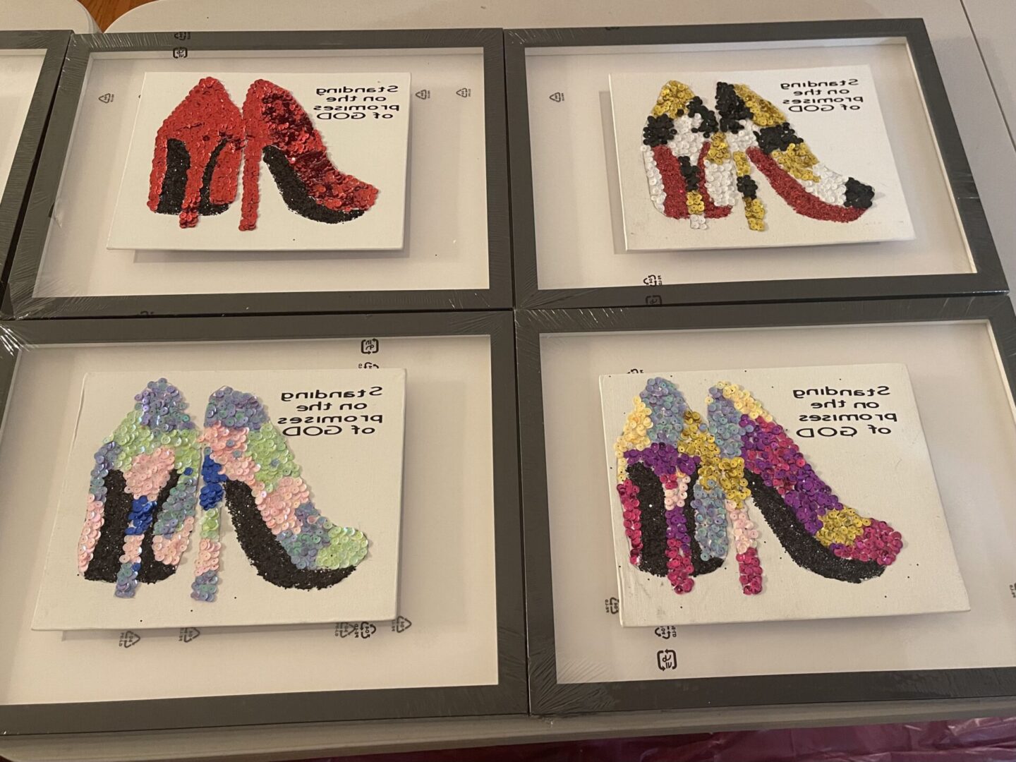 Four framed shoe illustrations with fashion quotes in stylish colors.